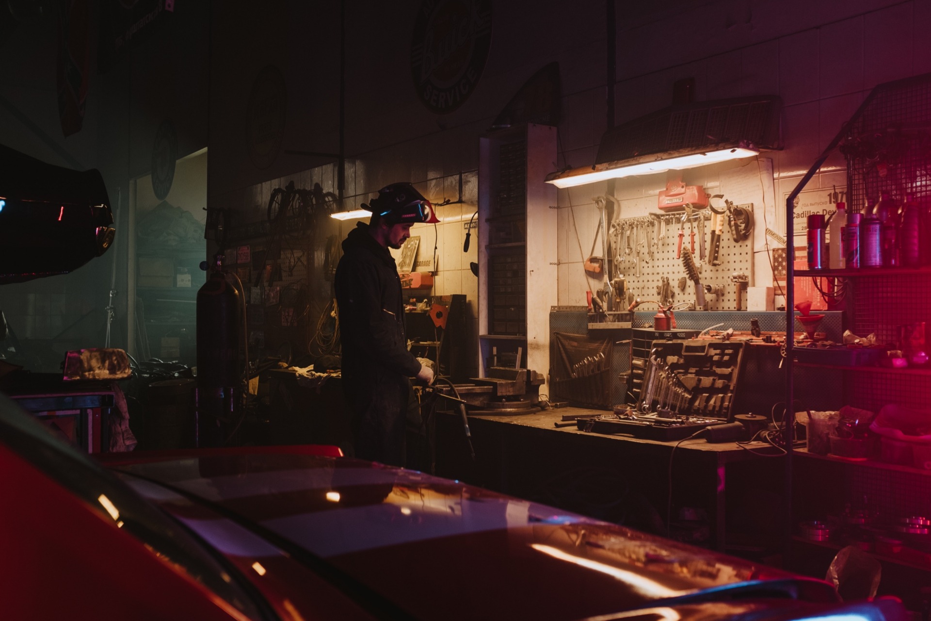 Man in Garage fixing something in the dark